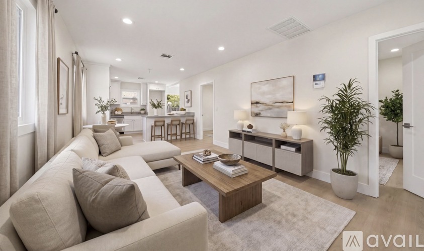 A well-lit, modern living room with a beige sofa and a coffee table.