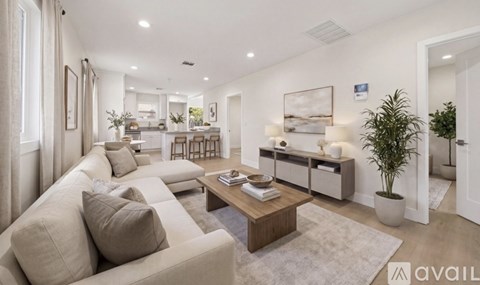 A well-lit, modern living room with a beige sofa and a coffee table.