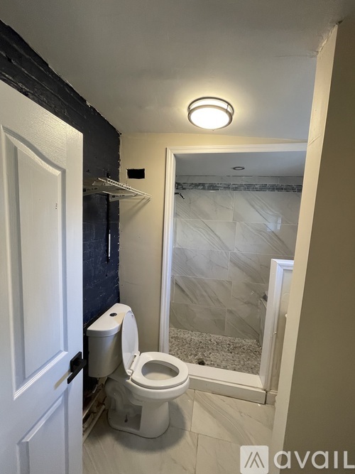 A white toilet in a bathroom with a white door.