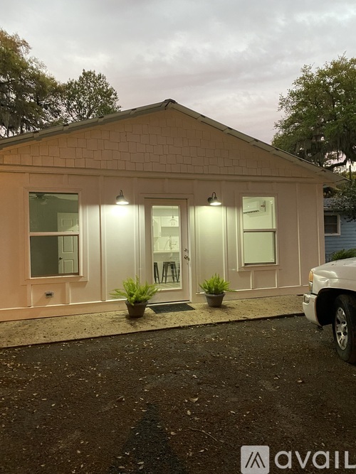 A small building with a white truck parked in front.
