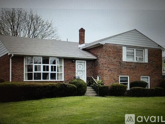 A house with a brick exterior and a white door is for sale.
