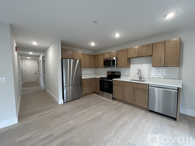 A kitchen with wooden cabinets and stainless steel appliances.