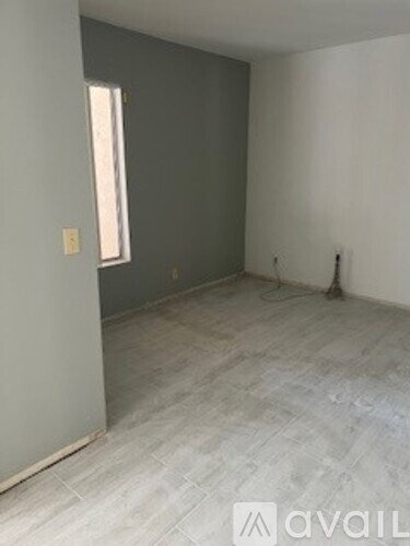 A room with grey walls and a window.