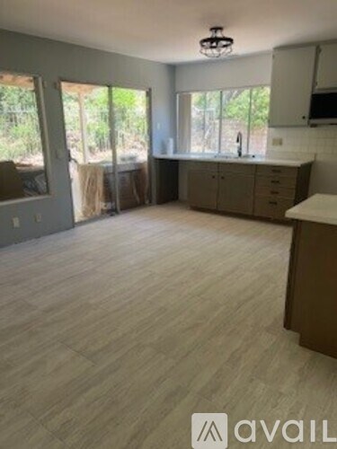 A kitchen area with a counter and cabinets is visible.