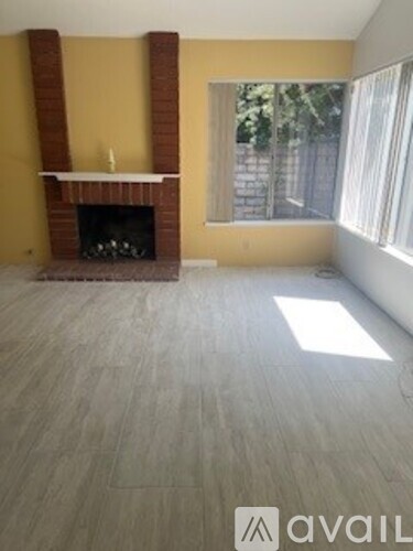 A room with a fireplace and a window.