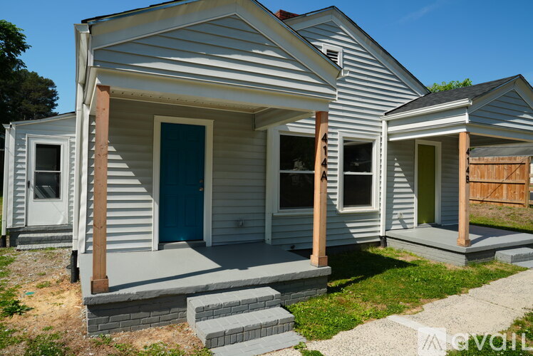 A house with a blue door and a white wall.