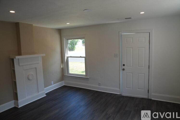 A room with a fireplace and a window.
