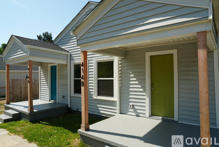 Two houses with blue and green doors are available for rent.