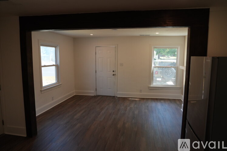 A room with wooden floors and white walls.