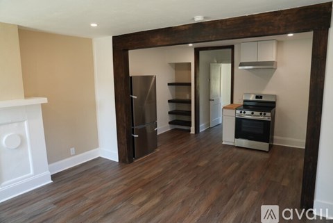 A kitchen with a refrigerator, oven, and stove is available for rent.