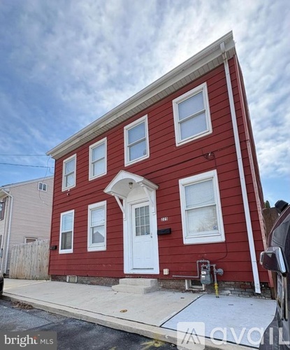 A red house with a white door and windows.