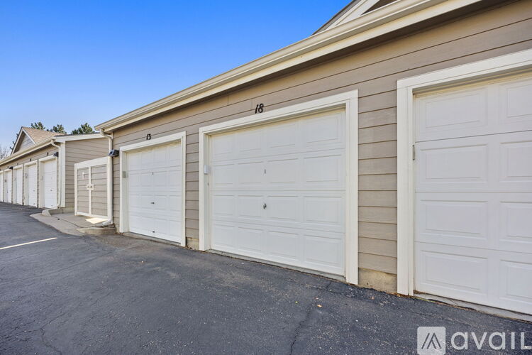 A row of garage doors in front of a building.