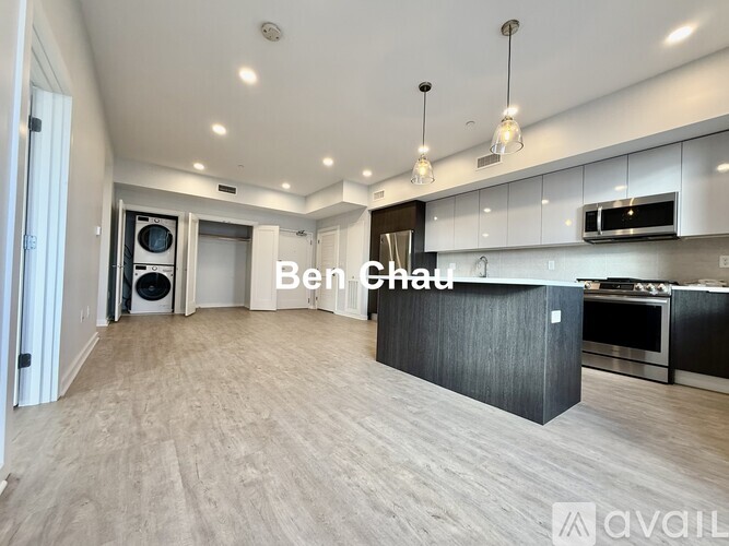 A spacious kitchen with a black countertop and a text overlay that reads "Ben Chad".