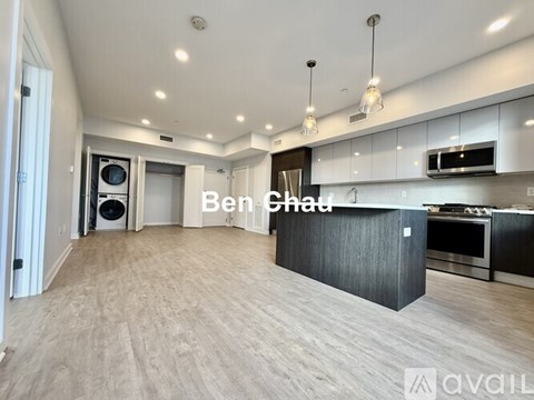 A spacious kitchen with a black countertop and a text overlay that reads "Ben Chad".