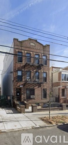 A brick building with a tree in front of it.