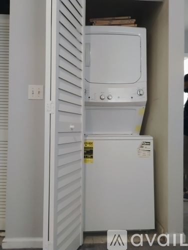 A white fridge with a freezer compartment on the bottom and a small cabinet on top.