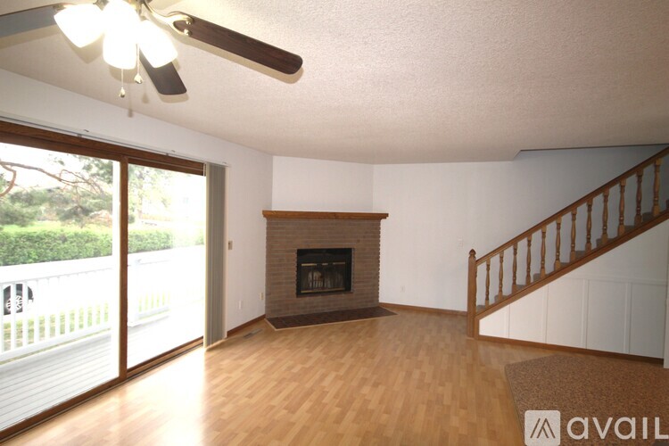 A living room with a fireplace and sliding glass doors.