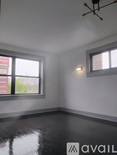 A room with a large window and a smaller window on the wall.