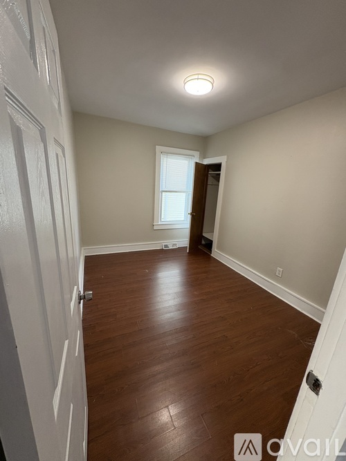 A room with wooden floors and white walls.
