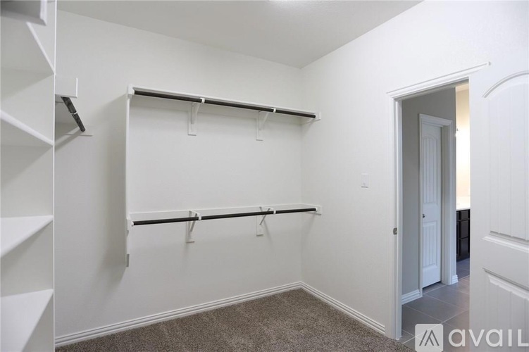 A white wall with a black bar and a doorway.