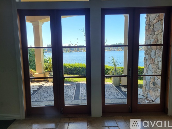 A view of a lake through a sliding glass door.