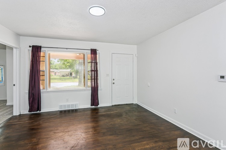 A room with a window and a door is available for rent.