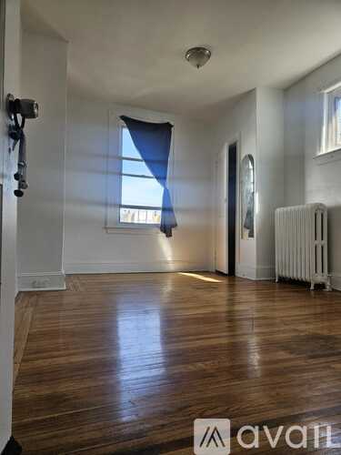 A room with wooden floors and white walls.