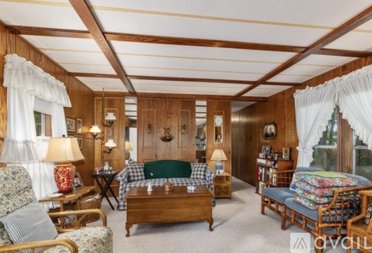 A cozy bedroom with a bed, chair, and table.