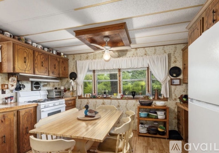 A kitchen with wooden cabinets and a white fridge.