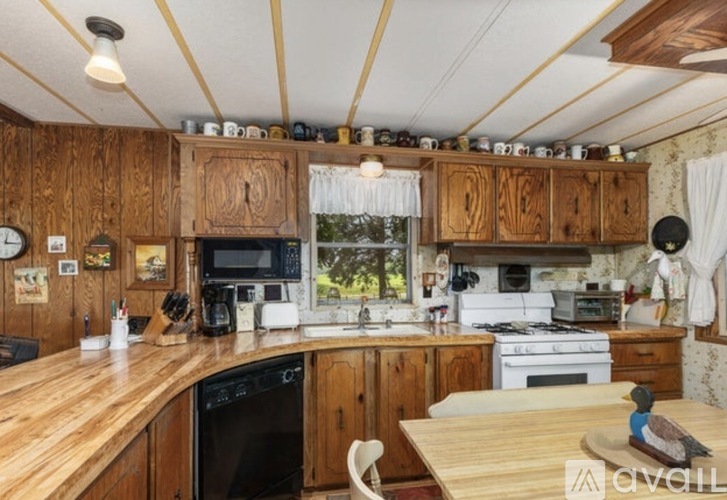 A kitchen with wooden cabinets and appliances.