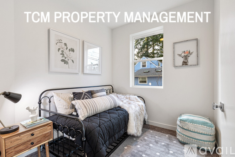 A bedroom with a bed, a nightstand, and pictures on the wall.