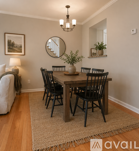 A dining room with a wooden table and chairs.