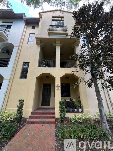 A white building with a balcony and a door.