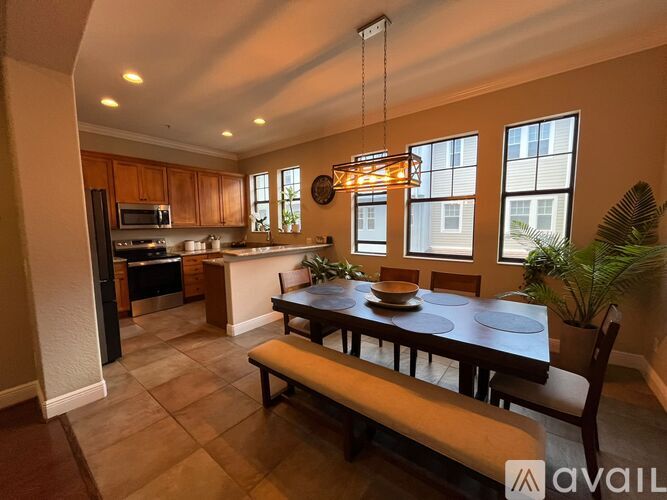A kitchen with a dining table and chairs is available for rent.