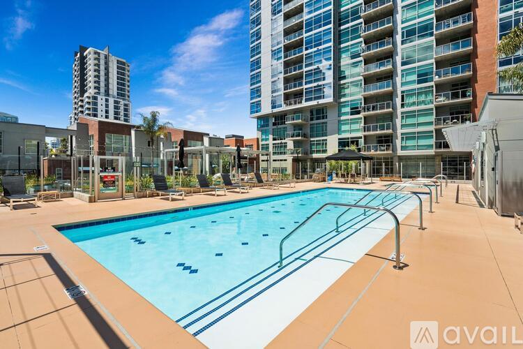 A large outdoor swimming pool surrounded by buildings.