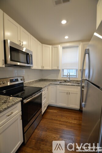 A kitchen with white cabinets and stainless steel appliances.