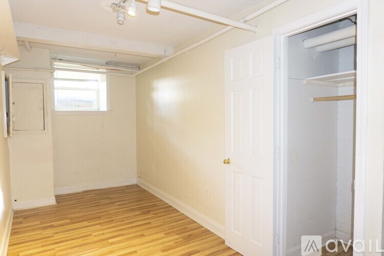 A small, empty room with a door and a window.