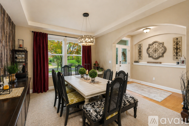 A dining room with a table set for six.