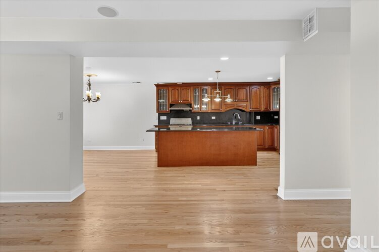 A kitchen with wooden cabinets and a central island.