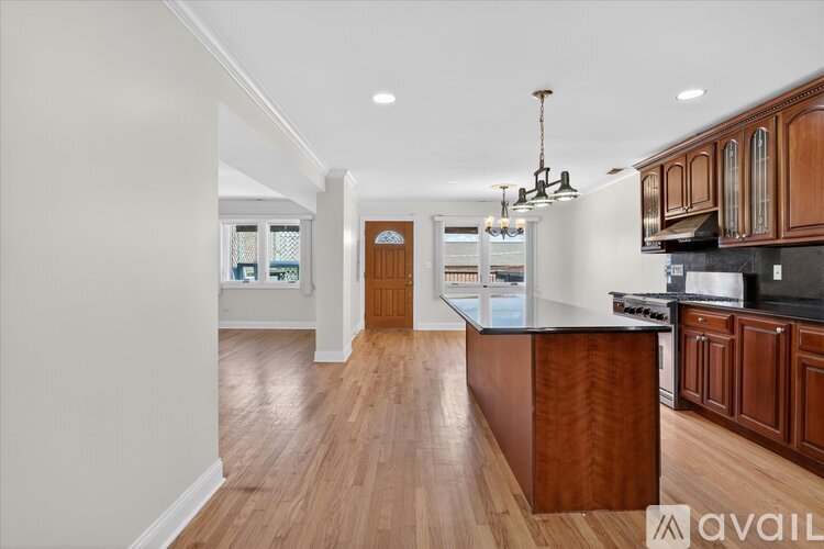 A kitchen with wooden floors and a central island.