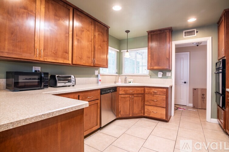 A kitchen with wooden cabinets and a white countertop.