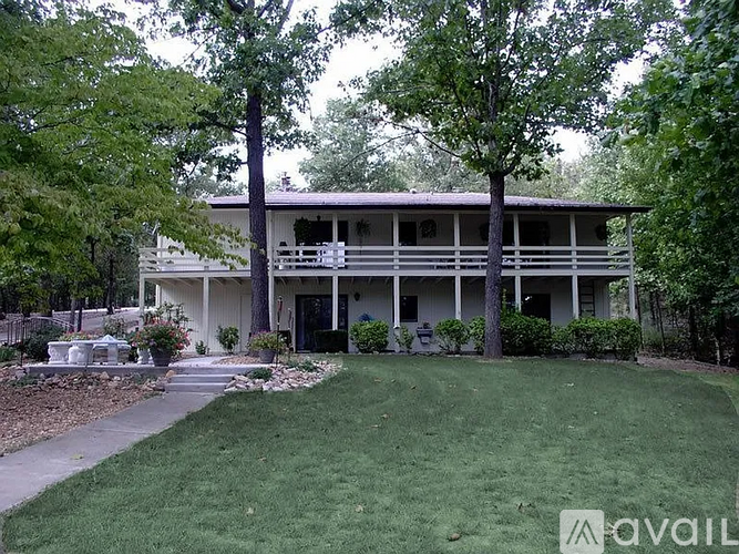 A two-story house with a balcony on the second floor.