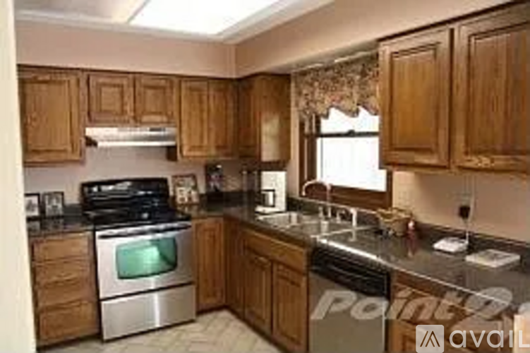 A kitchen with wooden cabinets and stainless steel appliances.