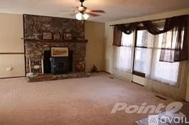 A living room with a fireplace and a television.