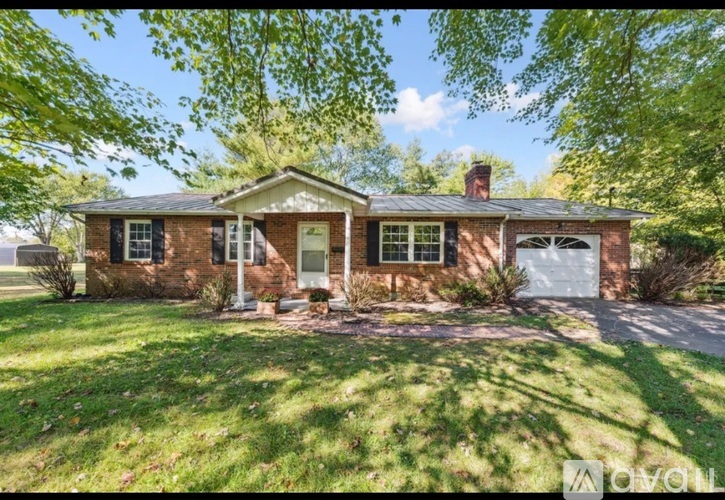 A house with a front yard and a driveway.