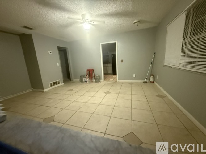 A room with a tiled floor and a ceiling fan.