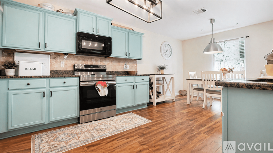 A kitchen with a stove top oven and a microwave.