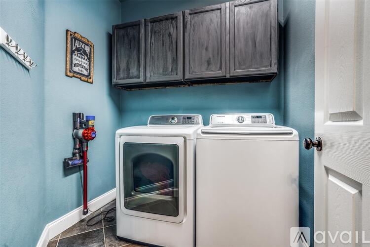 A white oven and microwave in a kitchen with blue walls.