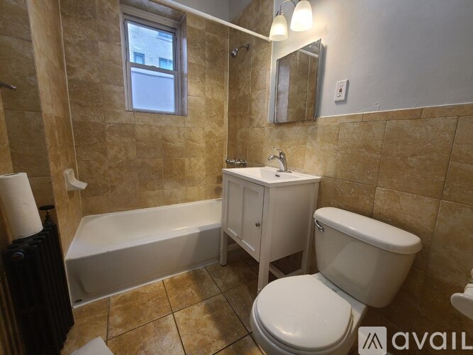 A bathroom with a toilet, sink, and bathtub.