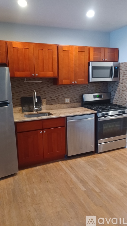 A kitchen with wooden cabinets and stainless steel appliances.